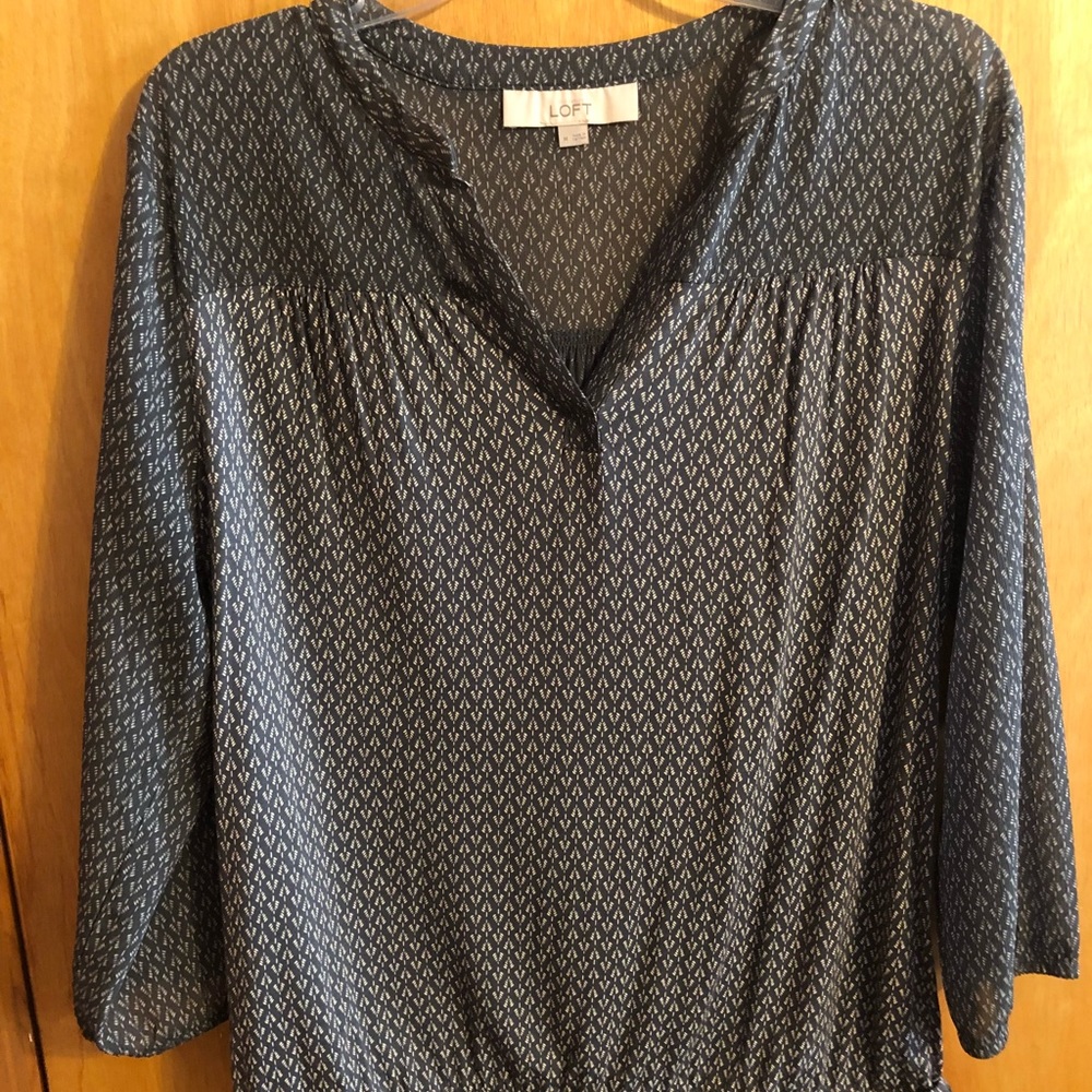 Gray and cream colored blouse